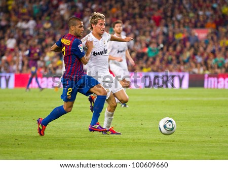 BARCELONA - AUGUST 17: Dani Alves (L) and Fabio Coentrao during the Spanish Super Cup final match between FC Barcelona and Real Madrid, 3 - 2, on August 17, 2011 in Camp Nou stadium, Barcelona, Spain.