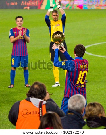 BARCELONA - JANUARY 15: Lionel Messi shows his third FIFA World Player Gold Ball Award to the soccer supporters of Football Club Barcelona, on January 15, 2012 in Nou Camp stadium, Barcelona, Spain.