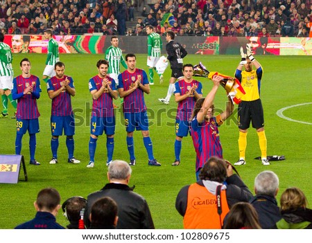 BARCELONA - JANUARY 15: Carles Puyol shows the FIFA Club World Cup to the soccer supporters of Football Club Barcelona, on January 15, 2012 in Nou Camp stadium, Barcelona, Spain.