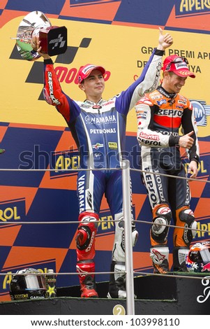 BARCELONA - JUNE 5: Jorge Lorenzo (2nd) celebrating his trophy in the podium after the race of MotoGP Grand Prix of Catalunya, on June 5, 2011 in Barcelona, Spain.