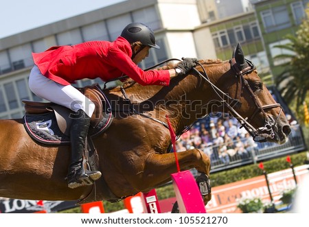 BARCELONA, SPAIN - SEPT 23: Thomas Couve of Chile in action rides horse Gold Digger  during the 100th CSIO event at the Real Club de Polo Barcelona on September 23, 2011 in Barcelona, Spain.