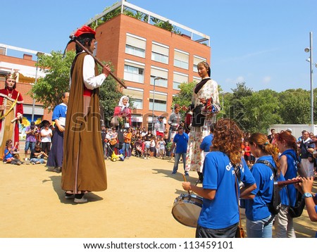 ALELLA, SPAIN - SEPTEMBER 09: Some unidentified people at La Verema Wine Festival, a traditional party of Alella, with a traditional parade of Giants, on September 9, 2012 in Alella, Barcelona, Spain.