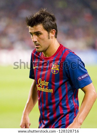 BARCELONA - SEPTEMBER 13: David Villa of FCB in action at the Champions League match between FC Barcelona and AC Milan, 2 - 2, on September 13, 2011, in Camp Nou, Barcelona, Spain.