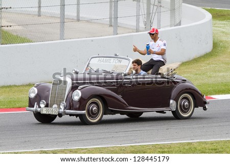 BARCELONA - MAY 13: Lewis Hamilton of McLaren driving a Mercedes classic car before the Formula One Spanish Grand Prix, on May 13, 2012 in Barcelona, Catalonia, Spain. The winner was Pastor Maldonado.
