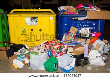 BARCELONA, SPAIN - JANUARY 6: Containers and trash after the Wise Men Kings event, who give toys to the children during this a traditional Spanish celebration, on January 6, 2011, in Barcelona, Spain.