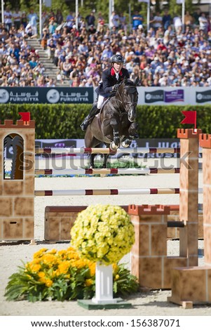 BARCELONA - SEPTEMBER 29: Ben Maher from Great Britain jumps a horse jumping obstacle at CSIO - Furusiyya FEI Nations Cup Horse Jumping Final Competition, on September 29, 2013, in Barcelona, Spain.
