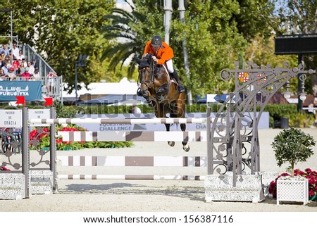 BARCELONA - SEPTEMBER 29: Jur Vrieling from Netherlands jumps a horse jumping obstacle at CSIO - Furusiyya FEI Nations Cup Horse Jumping Final Competition, on September 29, 2013, in Barcelona, Spain.