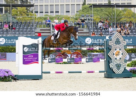 BARCELONA - SEPTEMBER 28: Taizo Sugitani from Japan jumps a horse jumping obstacle at CSIO - Furusiyya Nations Cup Horse Jumping Consolation Competition, on September 28, 2013, in Barcelona, Spain.