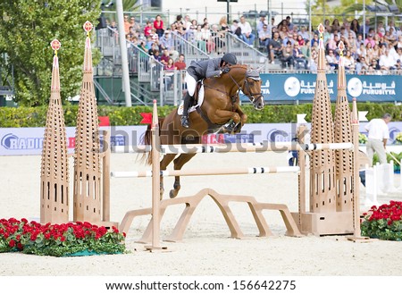 BARCELONA - SEPTEMBER 28: Julio Arias from Spain jumps a horse jumping obstacle at CSIO - Furusiyya Nations Cup Horse Jumping Consolation Competition, on September 28, 2013, in Barcelona, Spain.