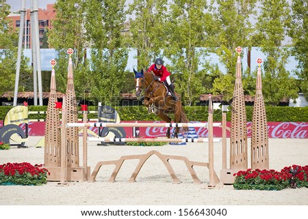 BARCELONA - SEPTEMBER 28: Lucy Davis from USA jumps a horse jumping obstacle at CSIO - Furusiyya Nations Cup Horse Jumping Consolation Competition, on September 28, 2013, in Barcelona, Spain.