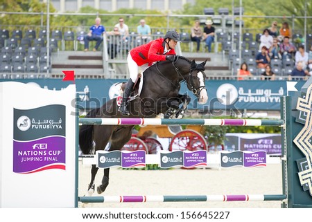 BARCELONA - SEPTEMBER 28: Beat Mandli from Switzerland jumps a horse jumping obstacle at CSIO - Furusiyya Nations Cup Horse Jumping Consolation Competition, on September 28, 2013, in Barcelona, Spain.