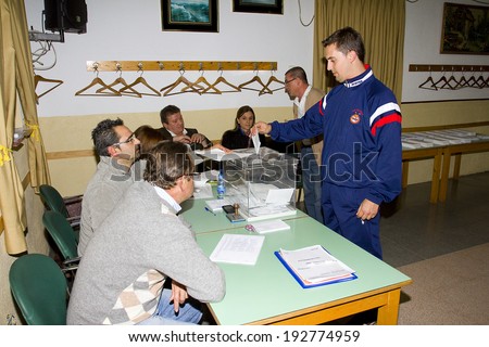 BARCELONA, SPAIN - NOVEMBER 25: An unidentified woman delivers his vote in a polling station during Catalonian parliamentary election, on November 25, 2012 in Barcelona, Spain.