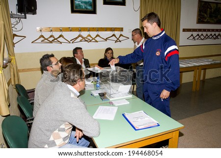 BARCELONA, SPAIN - NOVEMBER 25: An unidentified man delivers his vote in a polling station during Catalonian parliamentary election, on November 25, 2012 in Barcelona, Spain.