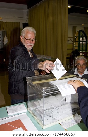 BARCELONA, SPAIN - NOVEMBER 25: An unidentified man delivers his vote in a polling station during Catalonian parliamentary election, on November 25, 2012 in Barcelona, Spain.
