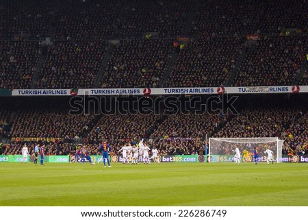 BARCELONA - JANUARY 25: Dani Alves (2) shooting a free kick at the Spanish Cup match between FC Barcelona and Real Madrid, final score 2 - 2, on January 25, 2012, in Camp Nou, Barcelona, Spain.