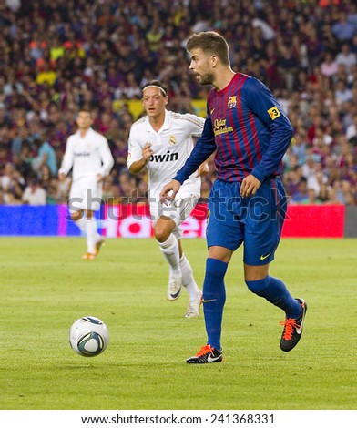 BARCELONA - AUGUST 17: Gerard Pique (R) of FCB in action at the Spanish Super Cup final match between FC Barcelona and Real Madrid, 3 - 2, on August 17, 2011 in Camp Nou stadium, Barcelona, Spain.