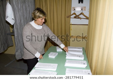 BARCELONA, SPAIN - NOVEMBER 25: An unidentified woman delivers his vote in a polling station during Catalonian parliamentary election, on November 25, 2012 in Barcelona, Spain.