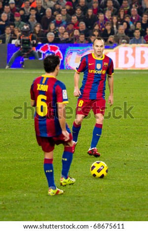 BARCELONA - DECEMBER 13: Nou Camp stadium, Spanish Soccer League match: FC Barcelona - Real Sociedad, 5 - 0. In the picture, Xavi and Iniesta in action. December 13, 2010 in Barcelona (Spain).
