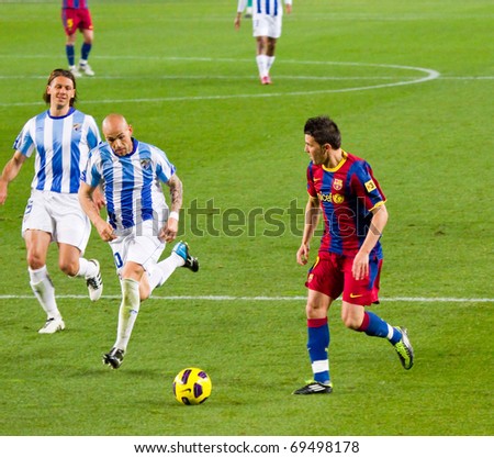 BARCELONA - JANUARY 16: Nou Camp football stadium, soccer Spanish League match: FC Barcelona - Malaga, 4 - 1. In the picture, David Villa in action. January 16, 2011 in Barcelona (Spain).