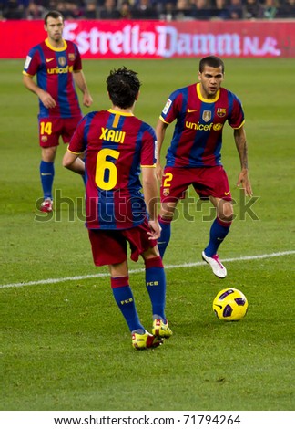 BARCELONA - DECEMBER 13: Nou Camp stadium, Spanish Soccer League match: FC Barcelona - Real Sociedad, 5 - 0. In the picture, Xavi (6) and Alves (2) in action. December 13, 2010 in Barcelona (Spain).