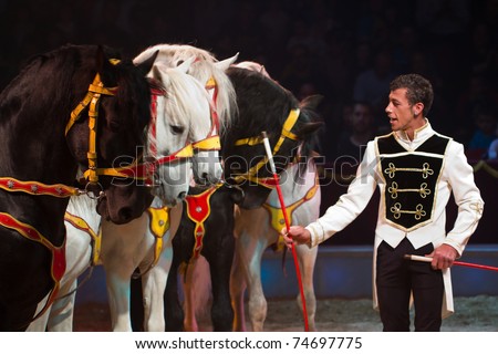 BARCELONA - APRIL 1: Tamer and horses in action during the spectacle Somnis (Dreams) of the circus Italiano on April 1, 2011, in Santa Coloma de Gramanet (Barcelona, Spain).