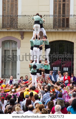 BARCELONA - MAY 1: Some unidentified people called Castellers do a Castell or Human Tower, typical tradition in Catalonia, on May 1, 2011 in Mollet del Valles, Spain.
