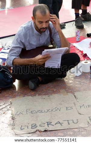 BARCELONA - MAY  19: Unidentified people protesting against unemployment and political corruption during the Spanish Revolution days, on May 19, 2011 in Catalunya square, Barcelona, Spain.
