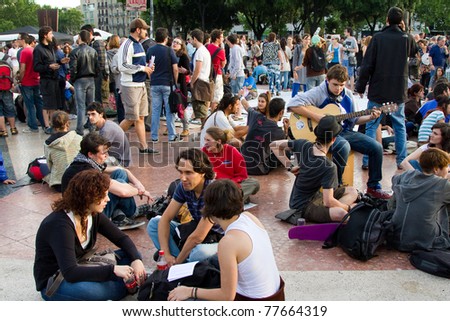 BARCELONA - MAY  19: People protest and do a peaceful sit-in against unemployment and political corruption during the Spanish Revolution days, on May 19, 2011 in Catalunya square, Barcelona, Spain.