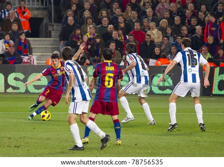 BARCELONA - DECEMBER 13: David Villa (L) in action during the Spanish Soccer League match between FC Barcelona and Real Sociedad, 5 - 0, in Camp Nou stadium on December 13, 2010 in Barcelona, Spain.