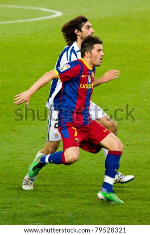BARCELONA - DECEMBER 13: David Villa (R) in action during the Spanish Soccer League match between FC Barcelona and Real Sociedad, 5 - 0, in Camp Nou stadium. December 13, 2010 in Barcelona (Spain).