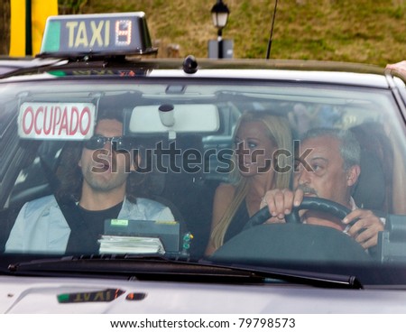 BARCELONA - JUNE 18: Belen Esteban (blond woman inside the car), a Spanish top celebrity, goes to the homosexual wedding of Luis Rollan, a famous journalist. June 18, 2011 in Alella, Barcelona, Spain.