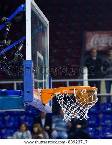 BARCELONA - MARCH 24: Ball inside the basket during the Euroleague basketball match between Barcelona and Panathinaikos, 71-75, on March 24, 2011 in Barcelona, Spain.