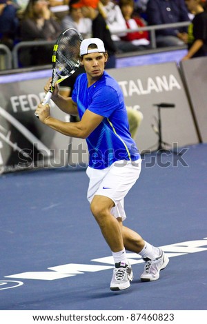 BARCELONA - OCTOBER 22: Rafa Nadal in action during a tennis match organized as a tribute to Andreu Gimeno, on October 22, 2011, in Palau Blaugrana stadium, Barcelona, Spain.