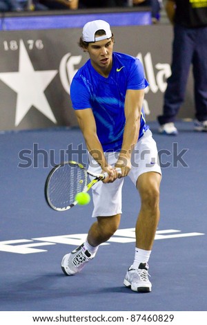 BARCELONA - OCTOBER 22: Rafa Nadal in action during a tennis match organized as a tribute to Andreu Gimeno, on October 22, 2011, in Palau Blaugrana stadium, Barcelona, Spain.