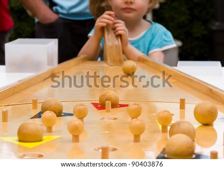 Children playing with an old wood game.