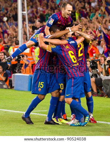 BARCELONA - AUGUST 17: Players celebrates the goal of Leo Messi during the Spanish Super Cup final match between FC Barcelona & Real Madrid, 3 - 2, on August 17, 2011 in Barcelona, Spain.