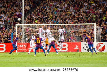 BARCELONA - SEPTEMBER 13: Leo Messi (10) shoots a free kick during the Champions League match between FC Barcelona and Milan, final score 2 - 2, on September 13, 2011, in Camp Nou, Barcelona, Spain.