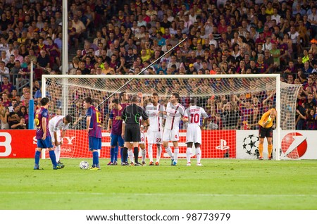 BARCELONA - SEPTEMBER 13: Leo Messi (10) shoots a free kick during the Champions League match between FC Barcelona and Milan, final score 2 - 2, on September 13, 2011, in Camp Nou, Barcelona, Spain.