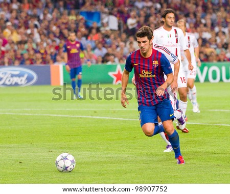 BARCELONA - SEPTEMBER 13: David Villa in action during the Champions League match between FC Barcelona and AC Milan, final score 2 - 2, on September 13, 2011, in Camp Nou, Barcelona, Spain.
