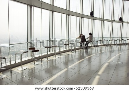 two silhouettes on the big window with panoramic view of Tokyo, Japan