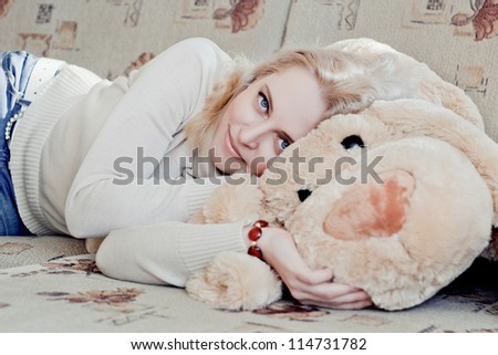Woman lying on couch with her toy doggy