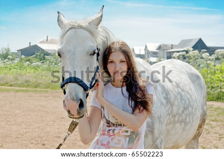 beautiful woman and white horse at rural area