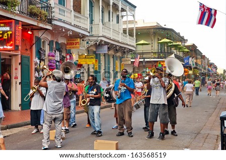 NEW ORLEANS - AUGUST 7: In New Orleans on Bourbon St. on August 7, 2013, a jazz band plays jazz melodies in the street for donations from the tourists and locals passing by on this hot summer evening.
