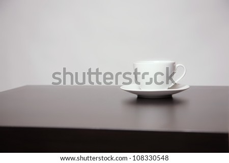 white coffee cup on a black table
