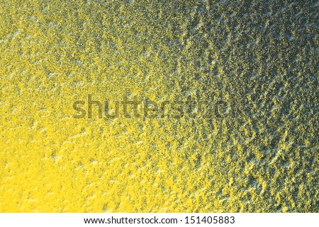 Abstract yellow splashes on green background texture