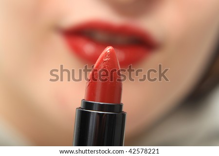 red lipstick and lips in the background
