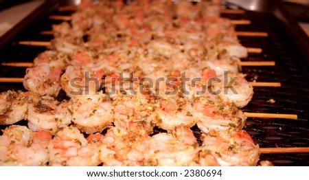 Shrimp marinated in oil and spices on bamboo skewers