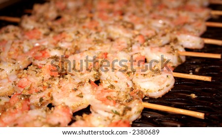 Shrimp marinated in oil and spices on bamboo skewers; shallow dof