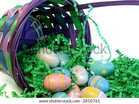 Easter basket filled with green fill and painted easter eggs