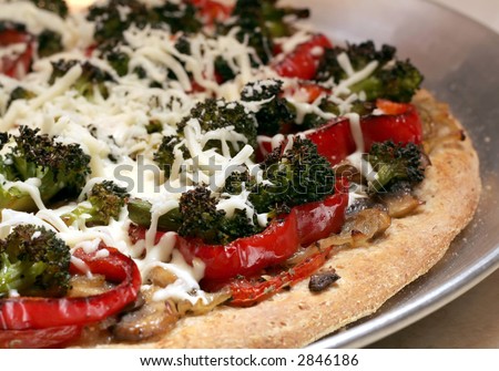 Healthy vegetable pizza on whole wheat crust ready for the oven